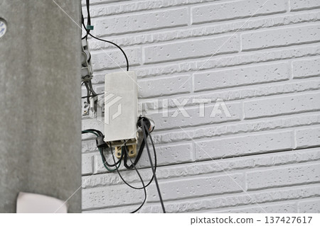 Internet, fiber optic lines, and telephones: Construction on the exterior walls of homes Internet, fiber optic lines, and telephones: Construction on the exterior walls of homes 137427617