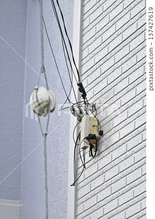 Internet, fiber optic lines, and telephones: Construction on the exterior walls of homes Internet, fiber optic lines, and telephones: Construction on the exterior walls of homes 137427619
