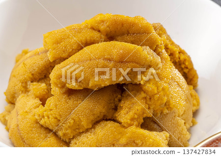 A pile of fresh raw sea urchin on a white plate from Shakotan, Hokkaido 137427834