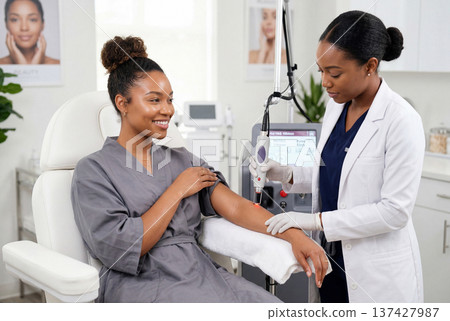 African american woman receiving laser hair removal treatment on her arm from a dermatologist 137427987