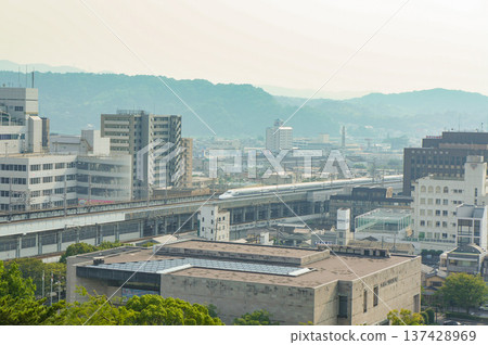 A Shinkansen train passing through Fukuyama Station and the cityscape A Shinkansen train passing through Fukuyama Station and the cityscape 137428969