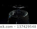 Collision of floating water droplets on a black background 137429548