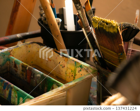 Artist Studio Workspace with Easel Paint Palette and Various Brushes 137431224