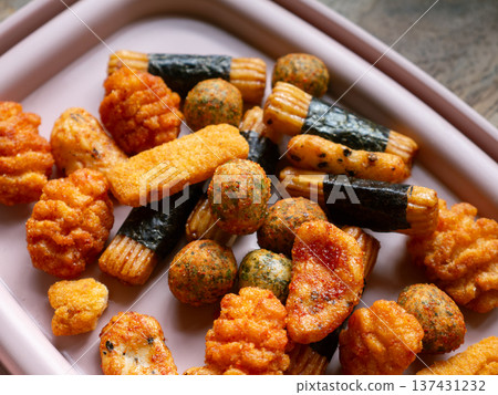 Assorted Japanese Rice Crackers and Snacks Mix Arare Senbei with Seaweed on White Plate - Traditional Asian Savory Snack Food 137431232