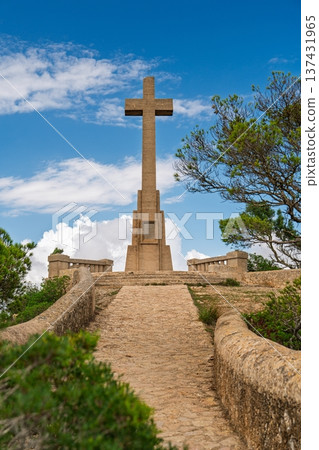Monumental Stone Cross Amidst Scenic Beauty in Mallorica, Spain A Symbol of Faith and History Monumental Stone Cross Amidst Scenic Beauty in Mallorica, Spain A Symbol of Faith and History 137431965