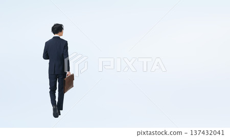 Full-body photo of a male businessman walking in a suit 137432041