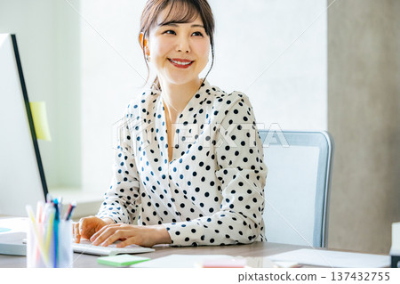 A young lady who operates a personal computer A young lady who operates a personal computer 137432755