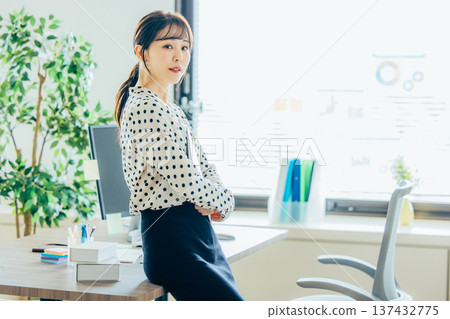 A young woman working in the office 137432775