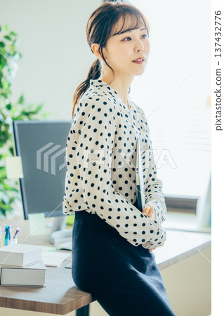 A young woman working in the office A young woman working in the office 137432776