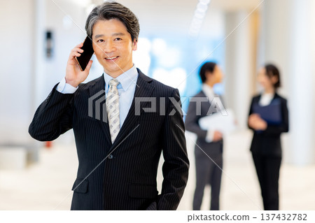 Middle-aged man looking at a smartphone Middle-aged man looking at a smartphone 137432782