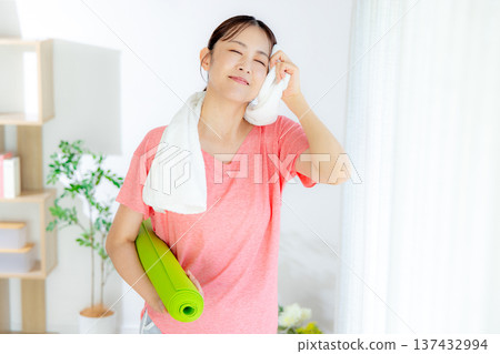 A woman wiping sweat while playing sports 137432994