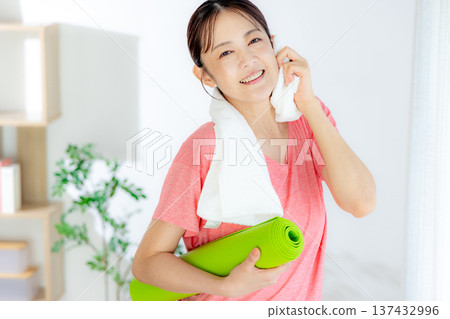 A woman wiping sweat while playing sports 137432996