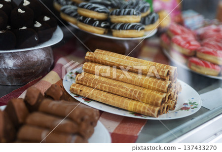 Bakery display delights. Warm sunlight illuminates fresh bakery merchandise attractively 137433270