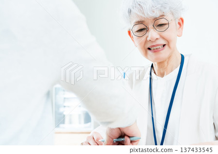 Senior woman receiving consultation Senior woman receiving consultation 137433545