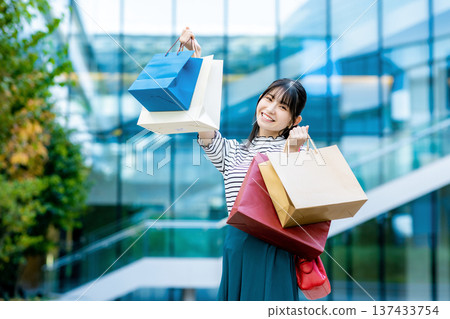 A young woman with a shopping bag A young woman with a shopping bag 137433754