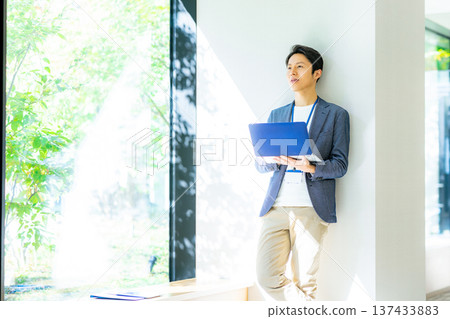 A businessman with a laptop computer A businessman with a laptop computer 137433883