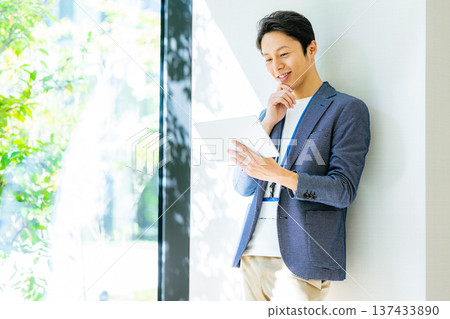 A businessman with a tablet 137433890