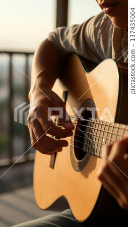 Close Up of Acoustic Guitar Playing at Sunset 137435004