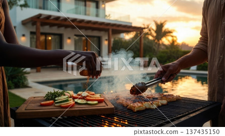 Seasoning meat on barbecue grill by pool at sunset Seasoning meat on barbecue grill by pool at sunset 137435150