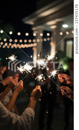 Group holding sparklers at outdoor night celebration Group holding sparklers at outdoor night celebration 137435176