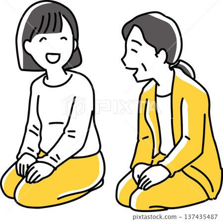 Two women talking while sitting upright 137435487