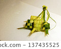 Traditional Ketupat Rice Dumplings Made of Woven Palm Leaves for Eid al-Fitr Celebration. Islamic Holiday Greeting for Ramadan Kareem and Eid Mubarak. . High quality photo Traditional Ketupat Rice Dumplings Made of Woven Palm Leaves for Eid al-Fitr Celebration. Islamic Holiday Greeting for Ramadan Kareem and Eid Mubarak. . High quality photo 137435525