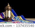 Traditional Arabic Lantern on Blue Prayer Mat with Copy Space. Ramadan and Eid Kareem Concept. High quality photo Traditional Arabic Lantern on Blue Prayer Mat with Copy Space. Ramadan and Eid Kareem Concept. High quality photo 137435540