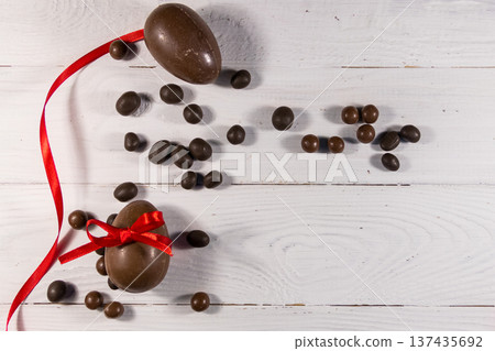 Easter composition with chocolate eggs on white wooden background Easter composition with chocolate eggs on white wooden background 137435692
