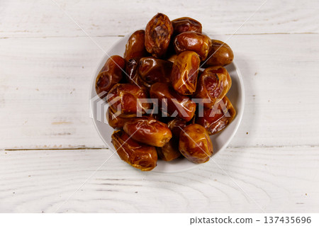 Dried dates fruit on white wooden table. Top view Dried dates fruit on white wooden table. Top view 137435696
