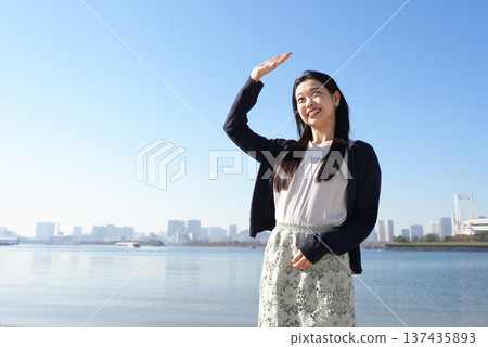 A young woman blocking the dazzling sunlight A young woman blocking the dazzling sunlight 137435893