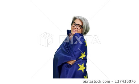 Mature woman embracing European Union flag showing unity Mature woman embracing European Union flag showing unity 137436076