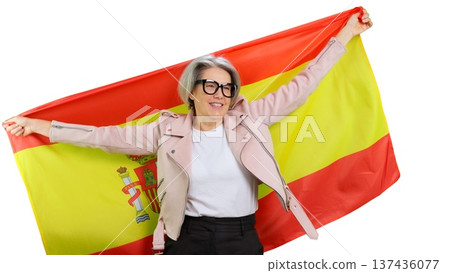 Mature woman holding a large Spain flag smiling with pride Mature woman holding a large Spain flag smiling with pride 137436077