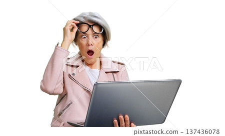 Senior woman reacting with shock seeing laptop content Senior woman reacting with shock seeing laptop content 137436078