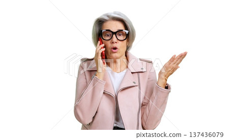 Senior woman talking on phone and gesturing discussion Senior woman talking on phone and gesturing discussion 137436079