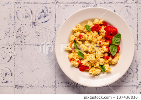 pasta in a plate with tomato sauce. pasta in a plate with tomato sauce. 137436836