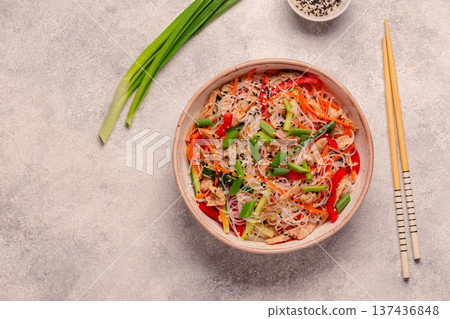 Bowl of rice noodles with vegan soy meat and vegetables. 137436848