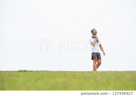 Man walking on the bank Man walking on the bank 137436927