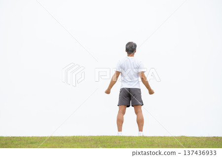 A man stretching on the bank, back view A man stretching on the bank, back view 137436933