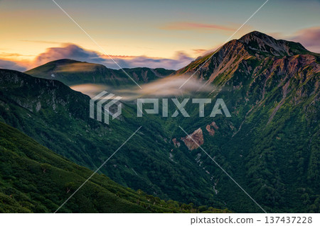The evening light of Mount Washu and Mount Sobu seen from Sugoroku hut in the Northern Alps 137437228