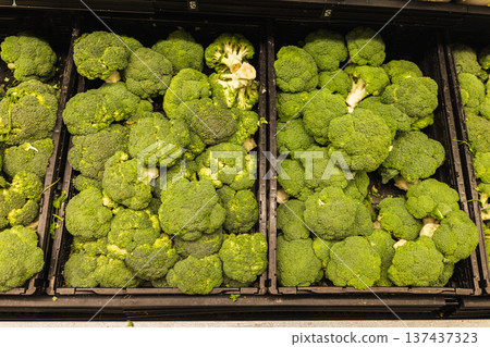 Fresh broccoli displayed in grocery store produce section 137437323