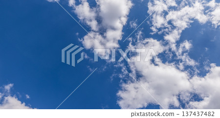 Dreamy sunny sky panorama fluffy white clouds glowing blue atmosphere peaceful summer cloudscape natural background Dreamy sunny sky panorama fluffy white clouds glowing blue atmosphere peaceful summer cloudscape natural background 137437482
