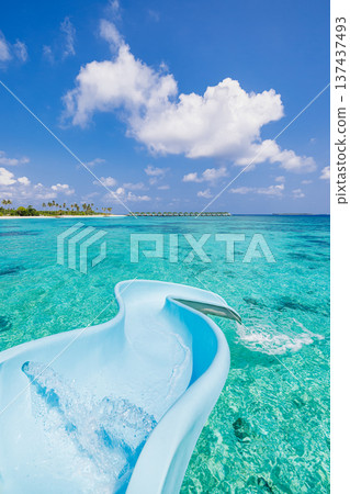 Maldives luxury water villa slide into pristine ocean lagoon bay tropical island paradise sunny summer holiday exotic travel destination Maldives luxury water villa slide into pristine ocean lagoon bay tropical island paradise sunny summer holiday exotic travel destination 137437493
