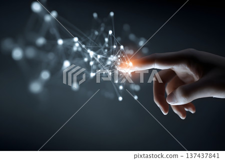 Hand touching a glowing digital interface with complex AI data points in a professional environment Hand touching a glowing digital interface with complex AI data points in a professional environment 137437841