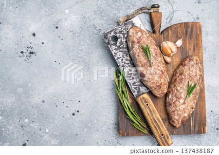 Succulent raw kofta kebab pieces marinated in spices, ideal for grilling enthusiasts looking to elevate their barbecue game. grey background. top view Succulent raw kofta kebab pieces marinated in spices, ideal for grilling enthusiasts looking to elevate their barbecue game. grey background. top view 137438187