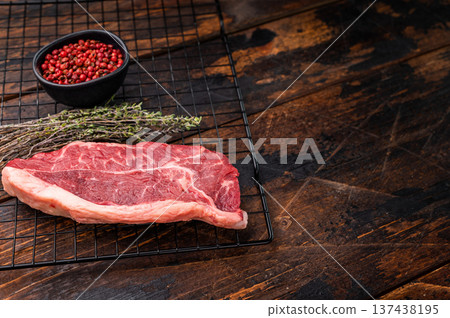 High quality raw striploin steak ready for seasoning, perfect for crafting the ultimate steak dinner experience. wooden background. top view High quality raw striploin steak ready for seasoning, perfect for crafting the ultimate steak dinner experience. wooden background. top view 137438195