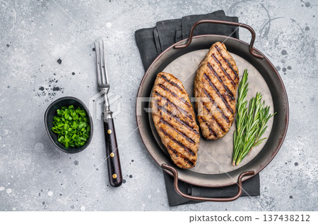Close up of succulent grilled kofta kebabs or kebaps, showcasing rich spices and a tantalizing golden-brown crust. grey background. top view Close up of succulent grilled kofta kebabs or kebaps, showcasing rich spices and a tantalizing golden-brown crust. grey background. top view 137438212