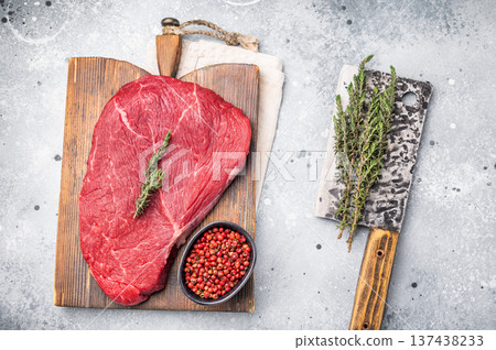 High quality raw top sirloin or rump beef steak, showcasing its rich flavor profile and tenderness, ideal for delicious meals. grey background. top view High quality raw top sirloin or rump beef steak, showcasing its rich flavor profile and tenderness, ideal for delicious meals. grey background. top view 137438233