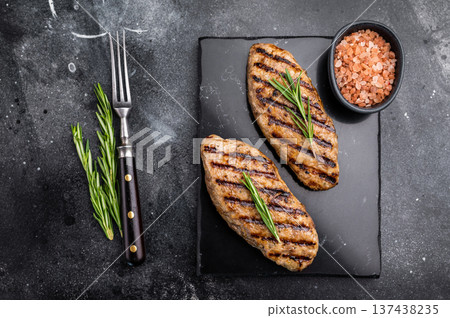 Grilled lula kebabs, perfect for an authentic Middle Eastern feast. black background. top view Grilled lula kebabs, perfect for an authentic Middle Eastern feast. black background. top view 137438235