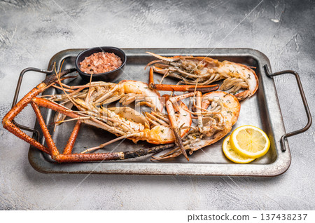 Deliciously grilled giant river prawns on steel tray, ideal for summer gatherings and outdoor feasts. white background. top view Deliciously grilled giant river prawns on steel tray, ideal for summer gatherings and outdoor feasts. white background. top view 137438237