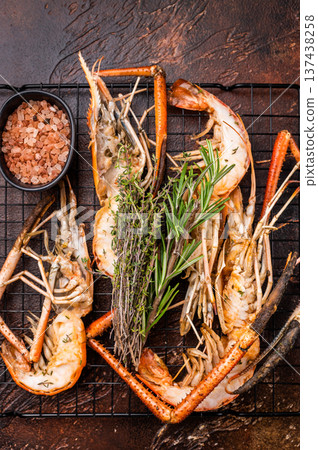 Savory grilled rosenbergii prawn drizzled with garlic butter, a luxurious treat for any seafood enthusiast. brown background. top view Savory grilled rosenbergii prawn drizzled with garlic butter, a luxurious treat for any seafood enthusiast. brown background. top view 137438258